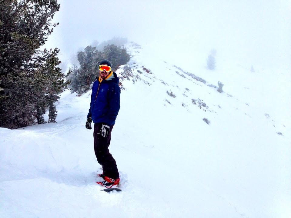 Brian standing on a snowy mountain ridge