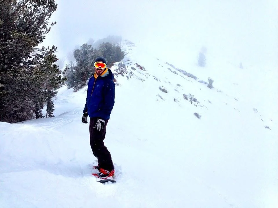 Brian standing on a snowy mountain ridge